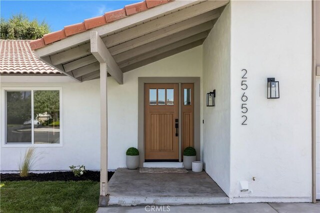 25652 Cervantes Ln, Mission Viejo, CA 92691 - view of exterior entry featuring stucco siding and a tile roof