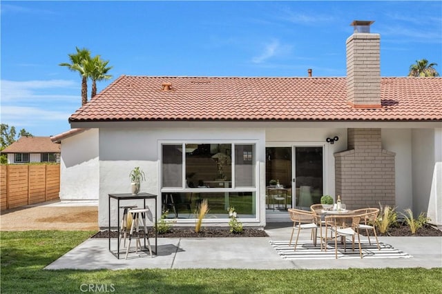 25652 Cervantes Ln, Mission Viejo, CA 92691 - rear view of house featuring a tile roof, a patio, a chimney, and stucco siding