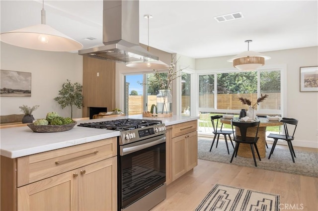 25652 Cervantes Ln, Mission Viejo, CA 92691 - kitchen featuring stainless steel range with gas cooktop, island range hood, light brown cabinetry, and light wood-style floors
