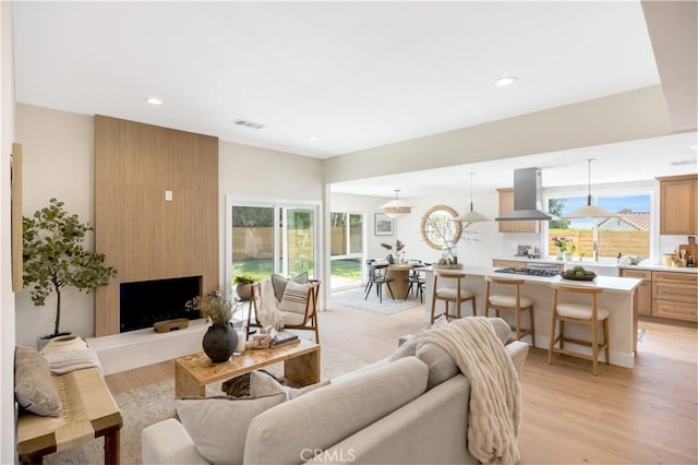 25652 Cervantes Ln, Mission Viejo, CA 92691 - living room featuring light wood-type flooring, recessed lighting, and a fireplace