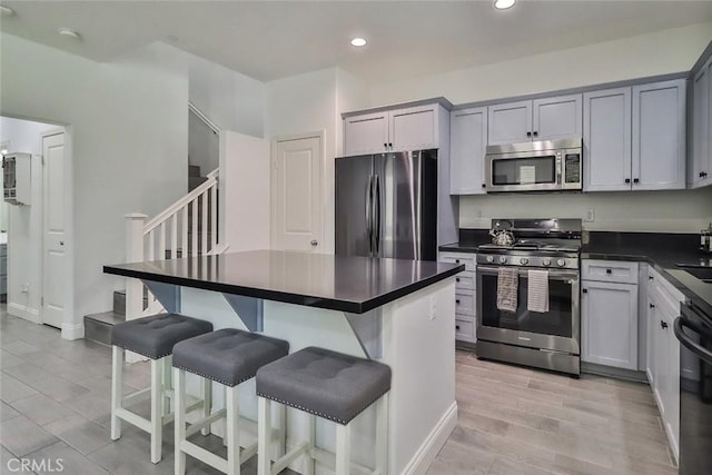 2928 Royal Ave, Simi Valley, CA 93065 - kitchen featuring stainless steel appliances, dark countertops, a kitchen bar, recessed lighting, and gray cabinets