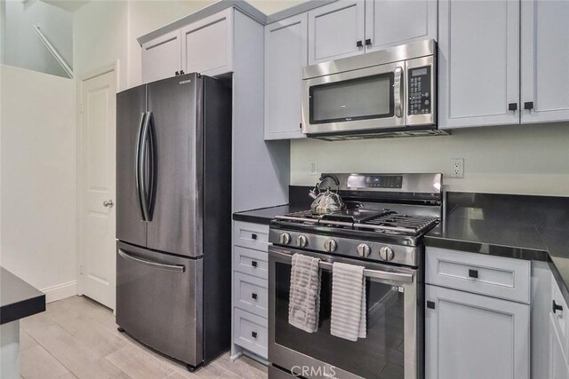 2928 Royal Ave, Simi Valley, CA 93065 - kitchen with appliances with stainless steel finishes, dark countertops, and light wood-style floors