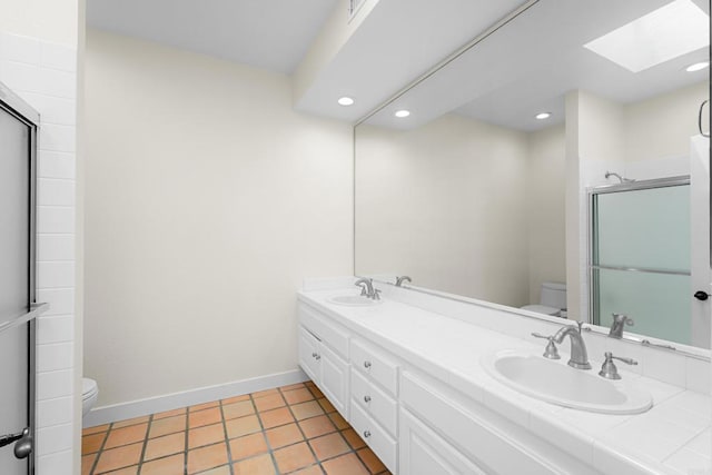 3647 Paseo Vista Famosa, Rancho Santa Fe, CA 92091 - full bath with a skylight, double vanity, a shower with shower door, recessed lighting, and tile patterned floors