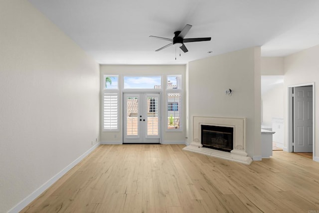 3647 Paseo Vista Famosa, Rancho Santa Fe, CA 92091 - unfurnished living room featuring french doors, light wood-style floors, ceiling fan, and a glass covered fireplace