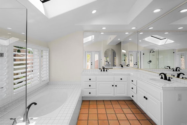3647 Paseo Vista Famosa, Rancho Santa Fe, CA 92091 - bathroom featuring a skylight, double vanity, a stall shower, a garden tub, and vaulted ceiling
