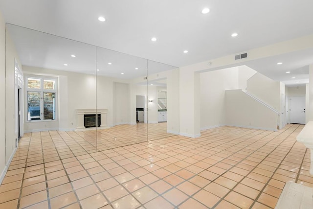 3647 Paseo Vista Famosa, Rancho Santa Fe, CA 92091 - unfurnished living room featuring light tile patterned floors, a glass covered fireplace, recessed lighting, and stairway