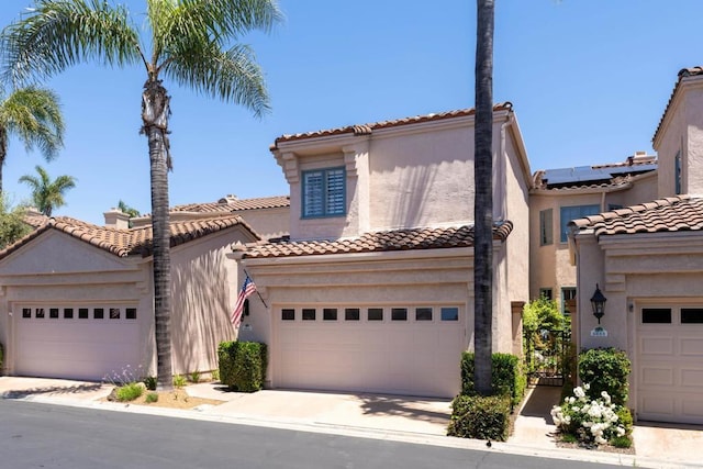 3647 Paseo Vista Famosa, Rancho Santa Fe, CA 92091 - mediterranean / spanish-style home featuring stucco siding, solar panels, a tiled roof, and driveway