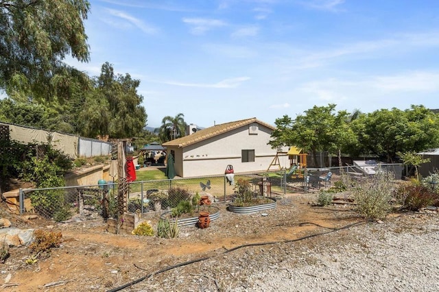 26267 Bellemore Dr, Ramona, CA 92065 - rear view of property with stucco siding, a garden, and a chimney