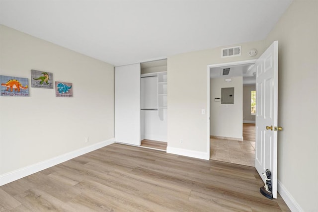 31916 Del Cielo Este Unit 38, Bonsall, CA 92003 - unfurnished bedroom featuring light wood-style floors, a closet, and electric panel