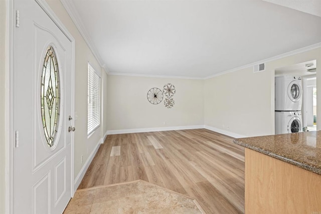 31916 Del Cielo Este Unit 38, Bonsall, CA 92003 - entrance foyer with stacked washing machine and dryer, ornamental molding, and light wood-style flooring