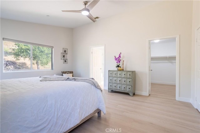 14114 Almetz Cir, Sylmar, CA 91342 - bedroom featuring light wood-style flooring, a walk in closet, and a ceiling fan