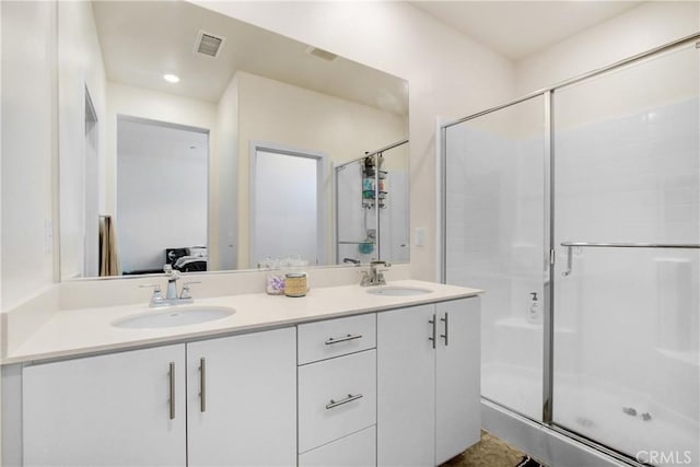 3934 Lavine Way Unit 108, Corona, CA 92883 - bathroom featuring double vanity, ensuite bathroom, a stall shower, and recessed lighting