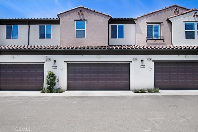 3934 Lavine Way Unit 108, Corona, CA 92883 - view of front of house featuring stucco siding, a garage, and a tiled roof