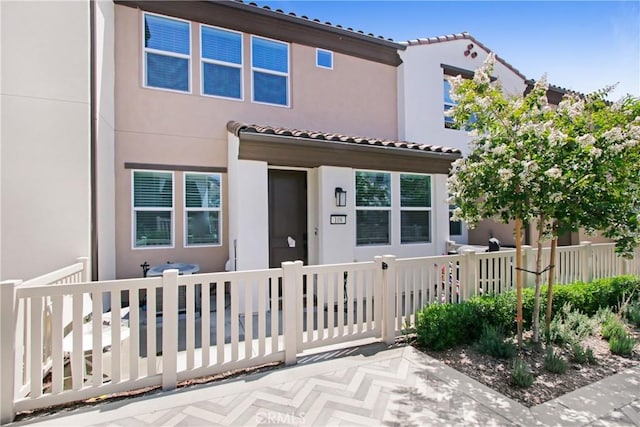 3934 Lavine Way Unit 108, Corona, CA 92883 - view of front of property with a tile roof and stucco siding
