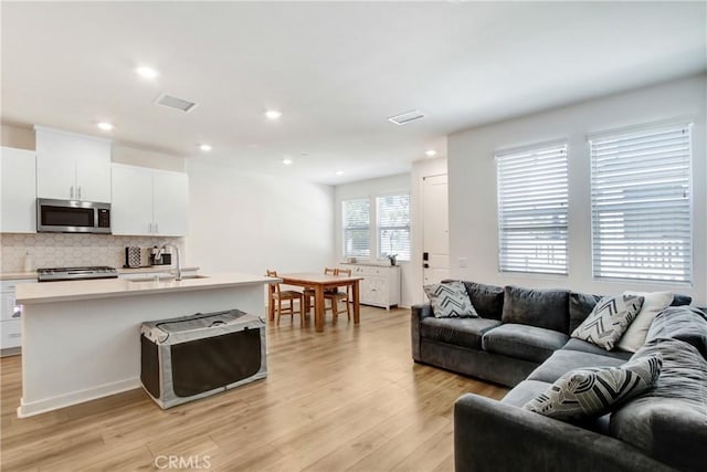 3934 Lavine Way Unit 108, Corona, CA 92883 - living area featuring light wood-style floors and recessed lighting
