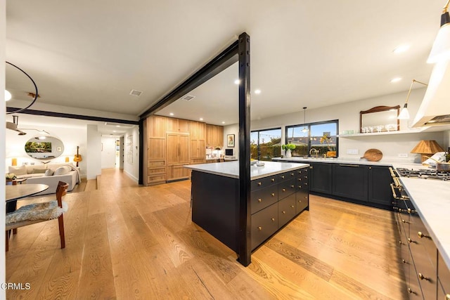 705 Alomar St, Ojai, CA 93023 - kitchen featuring dark cabinets, light countertops, a center island, open floor plan, and light wood-style floors