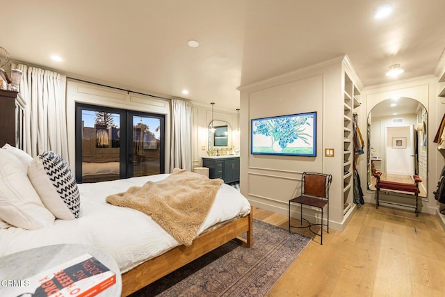 705 Alomar St, Ojai, CA 93023 - bedroom featuring access to outside, arched walkways, light wood-style flooring, crown molding, and french doors