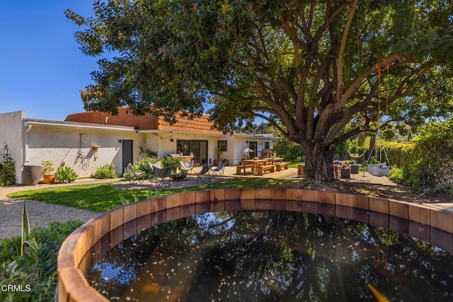 705 Alomar St, Ojai, CA 93023 - rear view of house with stucco siding, a patio, and a lawn