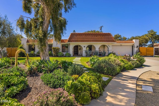 705 Alomar St, Ojai, CA 93023 - mediterranean / spanish-style home featuring stucco siding, a garage, a tiled roof, and driveway