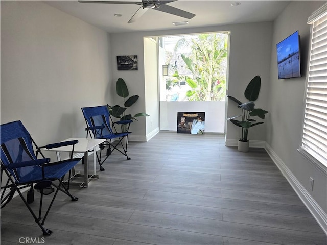 2774 Sawtelle Blvd, Los Angeles, CA 90064 - living area with healthy amount of natural light, a ceiling fan, and wood finished floors