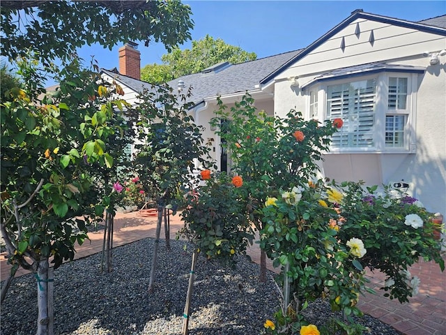 2774 Sawtelle Blvd, Los Angeles, CA 90064 - view of side of property with a chimney, stucco siding, and roof with shingles