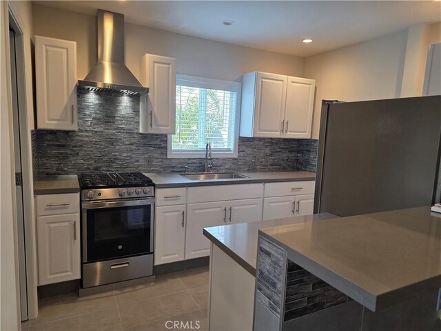 2774 Sawtelle Blvd, Los Angeles, CA 90064 - kitchen with appliances with stainless steel finishes, wall chimney exhaust hood, decorative backsplash, light tile patterned flooring, and white cabinetry