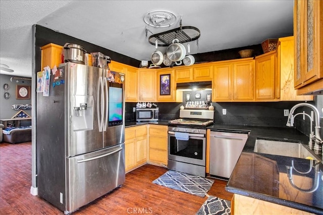 5982 Morongo Rd Unit 29, Palms, CA 92277 - kitchen with stainless steel appliances, dark countertops, and under cabinet range hood