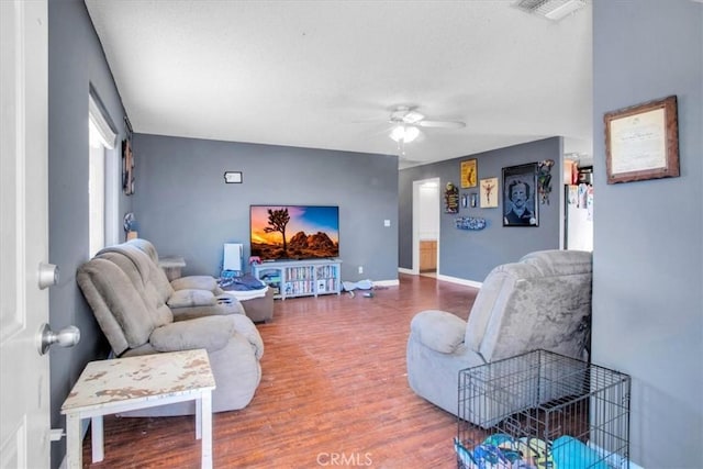 5982 Morongo Rd Unit 29, Palms, CA 92277 - living area with a ceiling fan and wood finished floors