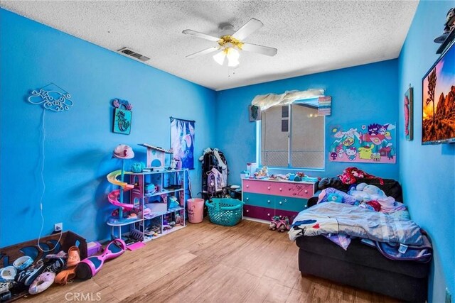 5982 Morongo Rd Unit 29, Palms, CA 92277 - bedroom with wood finished floors, a textured ceiling, and a ceiling fan