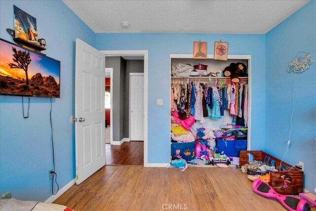5982 Morongo Rd Unit 29, Palms, CA 92277 - unfurnished bedroom with wood finished floors and a closet
