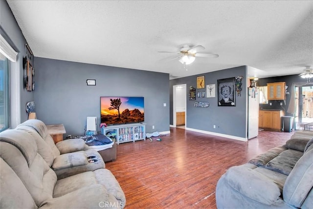 5982 Morongo Rd Unit 29, Palms, CA 92277 - living room featuring a ceiling fan, a textured ceiling, and wood finished floors