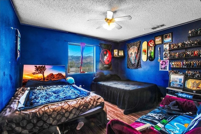 5982 Morongo Rd Unit 29, Palms, CA 92277 - bedroom with a textured ceiling, wood finished floors, and ceiling fan