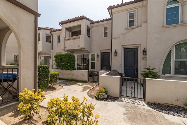 7019 Passons Blvd, Pico Rivera, CA 90660 - view of front facade with a gate, stucco siding, a tiled roof, and a fenced front yard