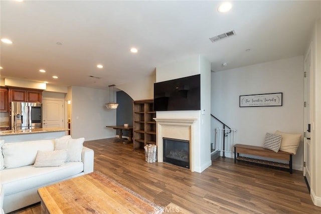 7019 Passons Blvd, Pico Rivera, CA 90660 - living area featuring recessed lighting, wood finished floors, and arched walkways