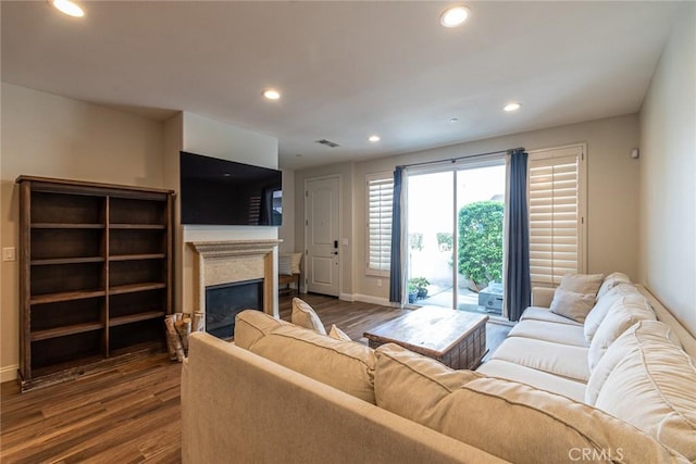 7019 Passons Blvd, Pico Rivera, CA 90660 - living room with dark wood finished floors, a glass covered fireplace, and recessed lighting