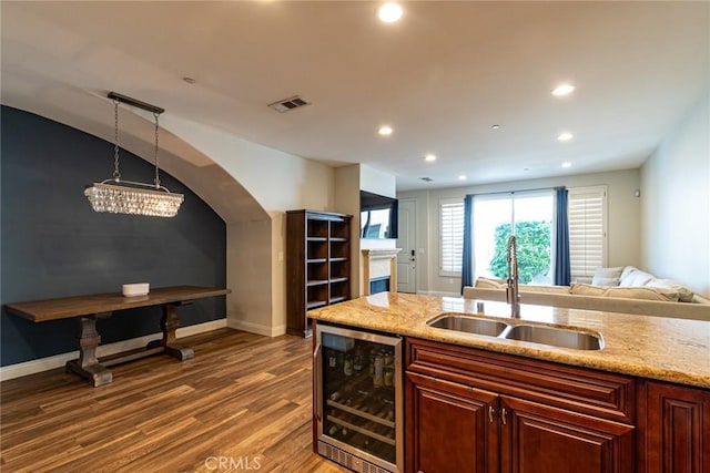 7019 Passons Blvd, Pico Rivera, CA 90660 - kitchen with wine cooler, wood finished floors, recessed lighting, open floor plan, and light stone counters