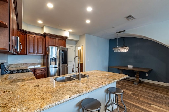 7019 Passons Blvd, Pico Rivera, CA 90660 - kitchen featuring stainless steel appliances, light stone counters, dark wood-style floors, a peninsula, and recessed lighting
