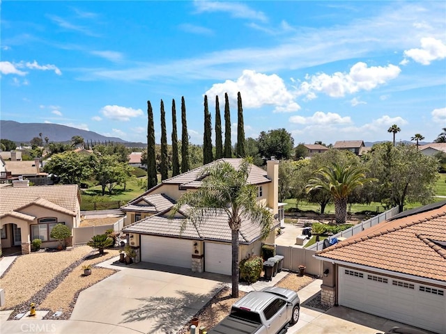 33087 Corte Ganso, Temecula, CA 92592 - view of front facade featuring a tiled roof, driveway, stone siding, and stucco siding