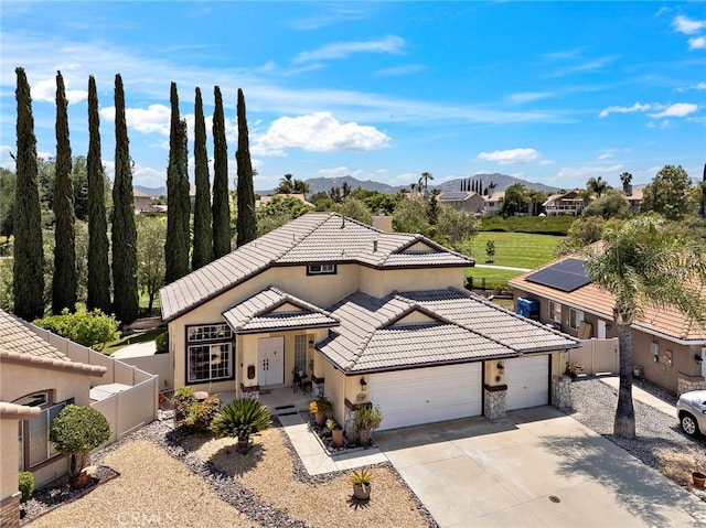33087 Corte Ganso, Temecula, CA 92592 - view of front facade with a garage, a tiled roof, a mountain view, driveway, and stucco siding