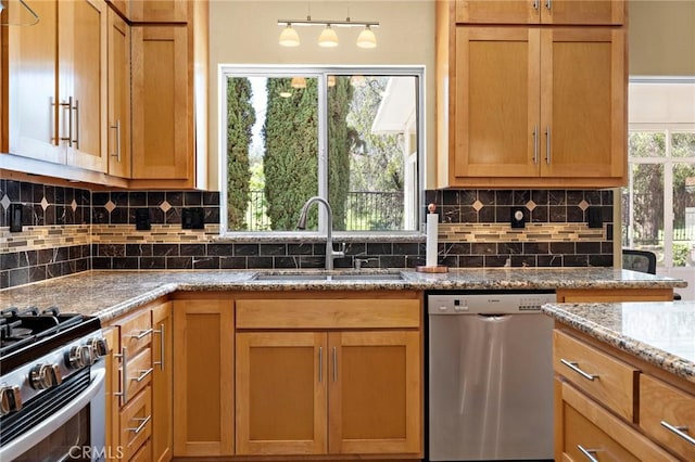33087 Corte Ganso, Temecula, CA 92592 - kitchen with stainless steel appliances, tasteful backsplash, stone counters, and brown cabinets