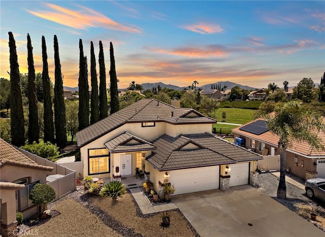33087 Corte Ganso, Temecula, CA 92592 - view of front of house featuring a garage, concrete driveway, a tile roof, stucco siding, and a mountain view