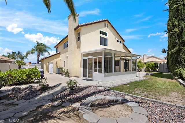33087 Corte Ganso, Temecula, CA 92592 - back of property featuring a sunroom, stucco siding, a patio, a chimney, and a tiled roof