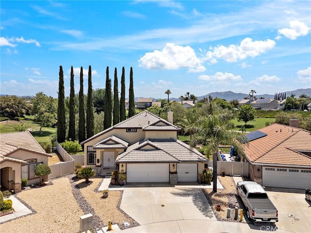 33087 Corte Ganso, Temecula, CA 92592 - view of front of house featuring a tile roof, concrete driveway, a chimney, a garage, and stucco siding