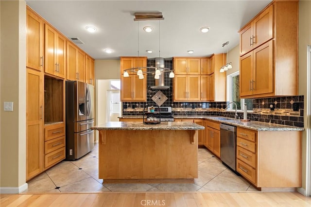 33087 Corte Ganso, Temecula, CA 92592 - kitchen with appliances with stainless steel finishes, wall chimney range hood, a kitchen island, and decorative backsplash