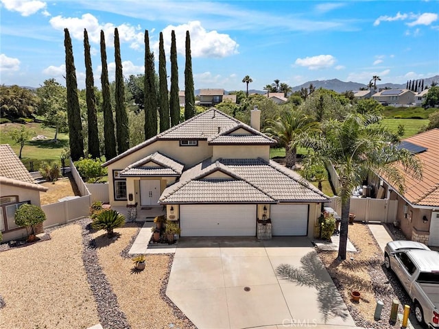 33087 Corte Ganso, Temecula, CA 92592 - view of front of home featuring a tile roof, a garage, driveway, stucco siding, and a chimney