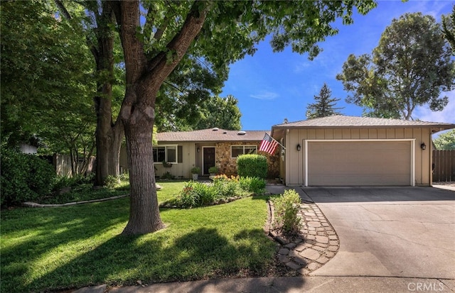 7 Calgary Ln, Chico, CA 95926 - ranch-style house with board and batten siding, driveway, a garage, and a front lawn