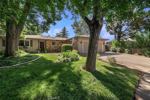 7 Calgary Ln, Chico, CA 95926 - ranch-style house with a garage, concrete driveway, board and batten siding, and a front lawn
