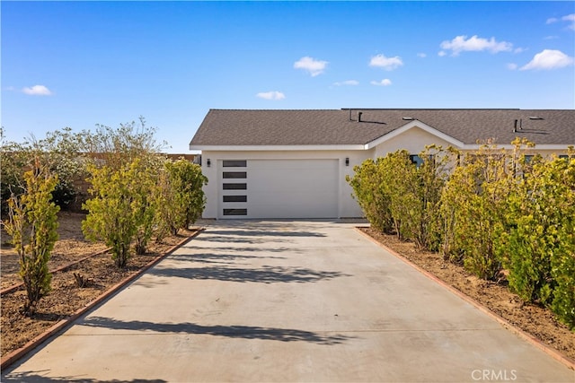 62290 Crestview Dr, Joshua Tree, CA 92252 - view of front facade with concrete driveway, a garage, and stucco siding