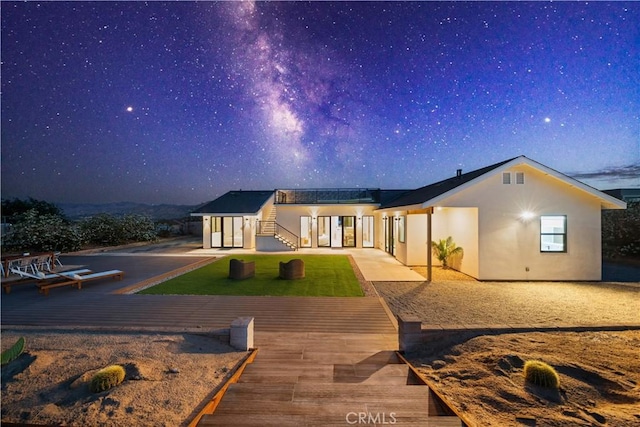 62290 Crestview Dr, Joshua Tree, CA 92252 - back of house with stucco siding and a wooden deck