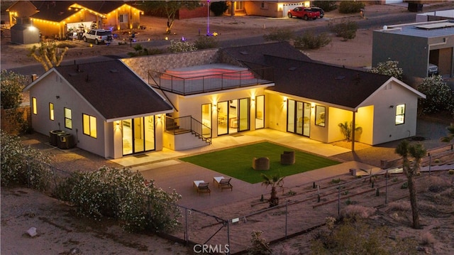 62290 Crestview Dr, Joshua Tree, CA 92252 - rear view of house with a balcony, stucco siding, a fenced backyard, and a patio